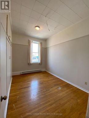 Brant (Paris) townhouse for rent - A room with wooden floors and a window with curtains.
