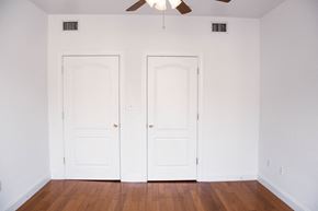 Jersey City apartment for rent - an empty room with two white doors and a ceiling fan