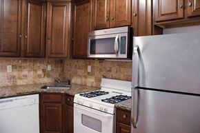 Jersey City apartment for rent - a kitchen with a stove microwave and refrigerator