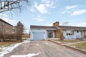 Stoney Creek house for rent - A blue house with a grey garage door in the front.