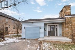 Stoney Creek house for rent - A house with a blue garage door and a brick chimney.