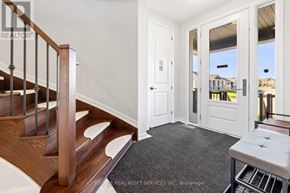 Ottawa house for rent - A wooden staircase with a metal railing and a marble floor.