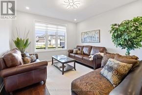 Ottawa house for rent - A living room with brown leather furniture and a large window.