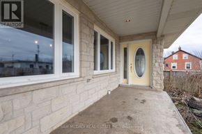 Grimsby (Grimsby Escarpment) house for rent - A real estate company's sign is on the window of a house.