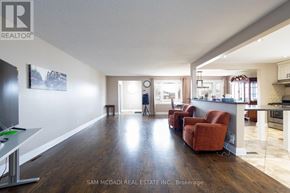 Grimsby (Grimsby Escarpment) house for rent - A well-lit living room with a kitchen area in the background.