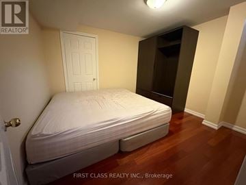Toronto (Highland Creek) house for rent - A bedroom with a bed, wardrobe and a door.