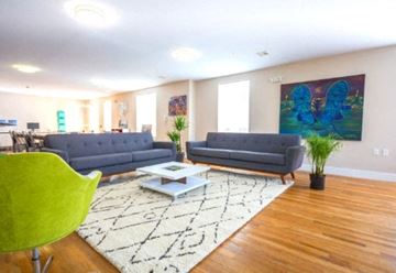Newark apartment for rent - a living room with two blue couches and a table