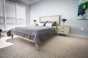 Orange apartment for rent - Bedroom model with carpeted floor and light wooden furniture