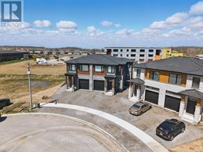 Niagara Falls (Brown) house for rent - A real estate brokerage logo is displayed on an aerial view of a residential area with houses and cars.