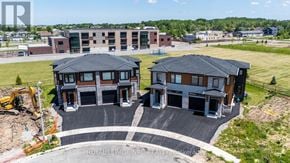 Niagara Falls (Brown) house for rent - A road with cars and a building with a yellow section in the middle of a field.