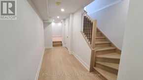 Niagara Falls (Brown) house for rent - A hallway with a staircase and a logo on the wall.