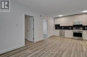 Ottawa house for rent - A realtor photo of a white room with a door and a kitchen area.