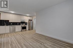 Ottawa house for rent - A spacious kitchen with wooden flooring and white walls.