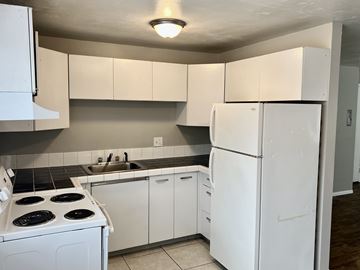 Denver apartment for rent - A kitchen with white appliances and cabinets.