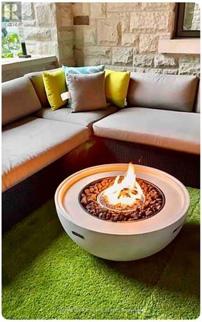 Toronto (Guildwood) house for rent - A modern outdoor seating area with a lit fire pit on a green rug.