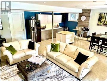 Toronto (Guildwood) house for rent - A living room with a white couch and a coffee table.