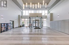 Hamilton (Corktown) multi-family for rent - A spacious lobby with a reception desk and a large glass window.