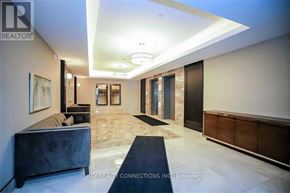 Hamilton (Stoney Creek) condo for rent - A spacious hallway with a bench, a painting, and a door.