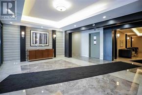 Hamilton (Stoney Creek) condo for rent - A hallway with a black carpet and a white ceiling.