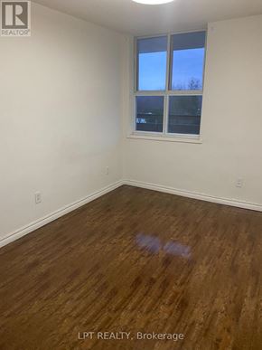 Markham (Royal Orchard) condo for rent - A room with wooden flooring and a window showing a blue sky.