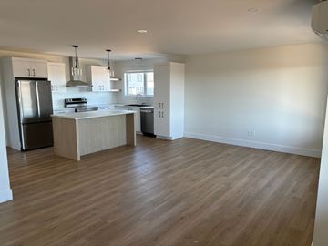 Moncton apartment for rent - A kitchen with a refrigerator, sink, and stove.