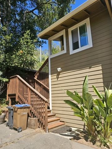 San Rafael apartment for rent - A house with a brown siding and a brown wooden staircase.