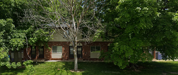 Mount Zion apartment for rent - A tree stands in front of a red brick building.