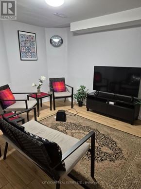 Mississauga (Churchill Meadows) house for rent - A living room with a sofa, chairs, and a television.
