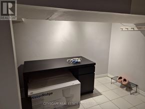 Mississauga (Churchill Meadows) house for rent - A room with a black desk and a box of WaterRidge.