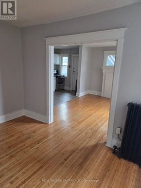 Hamilton (Crown Point) multi-family for rent - A room with wooden floors and white walls.