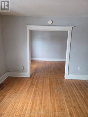 Hamilton (Crown Point) multi-family for rent - A room with wooden floors and white walls.