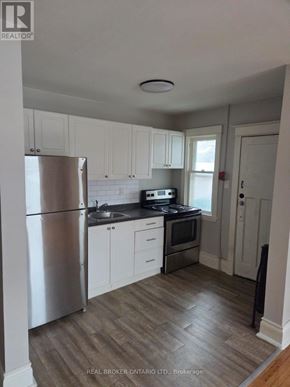 Hamilton (Crown Point) multi-family for rent - A kitchen with white cabinets and a stainless steel refrigerator.