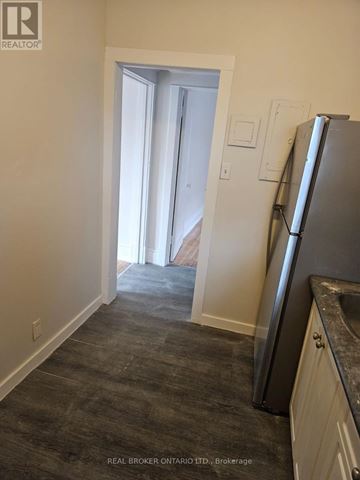 Hamilton (Crown Point) multi-family for rent - A kitchen with a refrigerator and a doorway leading to another room.
