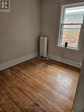 Hamilton (Crown Point) multi-family for rent - A room with a window and a radiator on the wall.