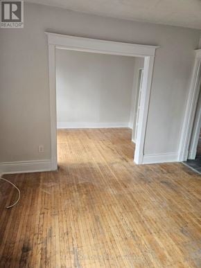 Hamilton (Crown Point) multi-family for rent - A room with wooden floors and white walls.