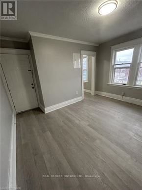 Hamilton (Crown Point) multi-family for rent - A room with wood flooring and a window overlooking a street.