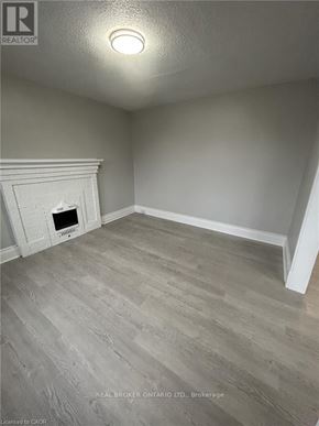 Hamilton (Crown Point) multi-family for rent - A room with a fireplace and wood flooring.
