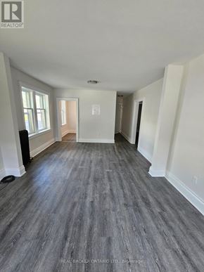Hamilton (Crown Point) multi-family for rent - A spacious room with wood flooring and white walls.
