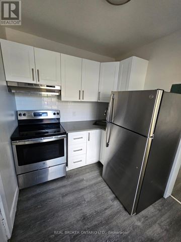 Hamilton (Crown Point) multi-family for rent - A kitchen with a stainless steel refrigerator, oven, and microwave.