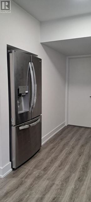 Innisfil (Alcona) house for rent - A stainless steel refrigerator with its door open in a room with wooden flooring.