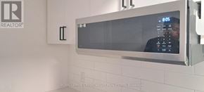 Innisfil (Alcona) house for rent - A microwave oven with the time 9:05 displayed on the screen.