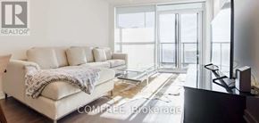 Toronto (Niagara) condo for rent - A living room with a couch and a television.