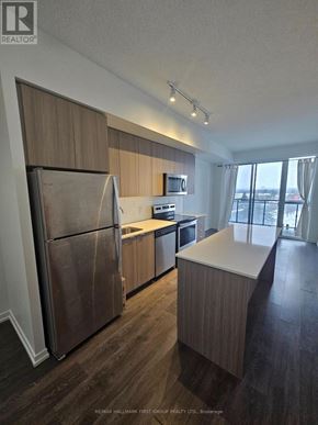 Toronto (Bayview Woods-Steeles) condo for rent - A kitchen with a refrigerator, sink, and countertops.