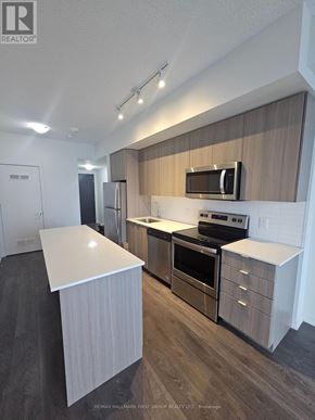 Toronto (Bayview Woods-Steeles) condo for rent - A kitchen with a refrigerator, microwave, oven and dishwasher.