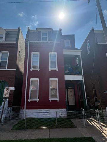 St Louis apartment for rent - A red brick building with a white door and windows.