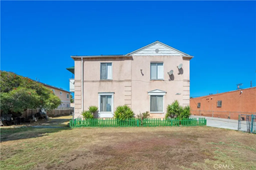Los Angeles apartment for rent - A two-story house with a green fence in front.