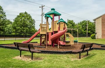 Memphis apartment for rent - A playground with a red slide and a green roof.