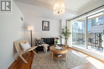 Toronto (Church-Yonge Corridor) condo for rent - A living room with a couch, chair, and a table with a plant on it.