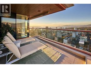 Vancouver apartment for rent - A balcony with a couch and a table with a potted plant on it.