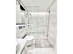 Vancouver apartment for rent - A white bathroom with a glass shower door.